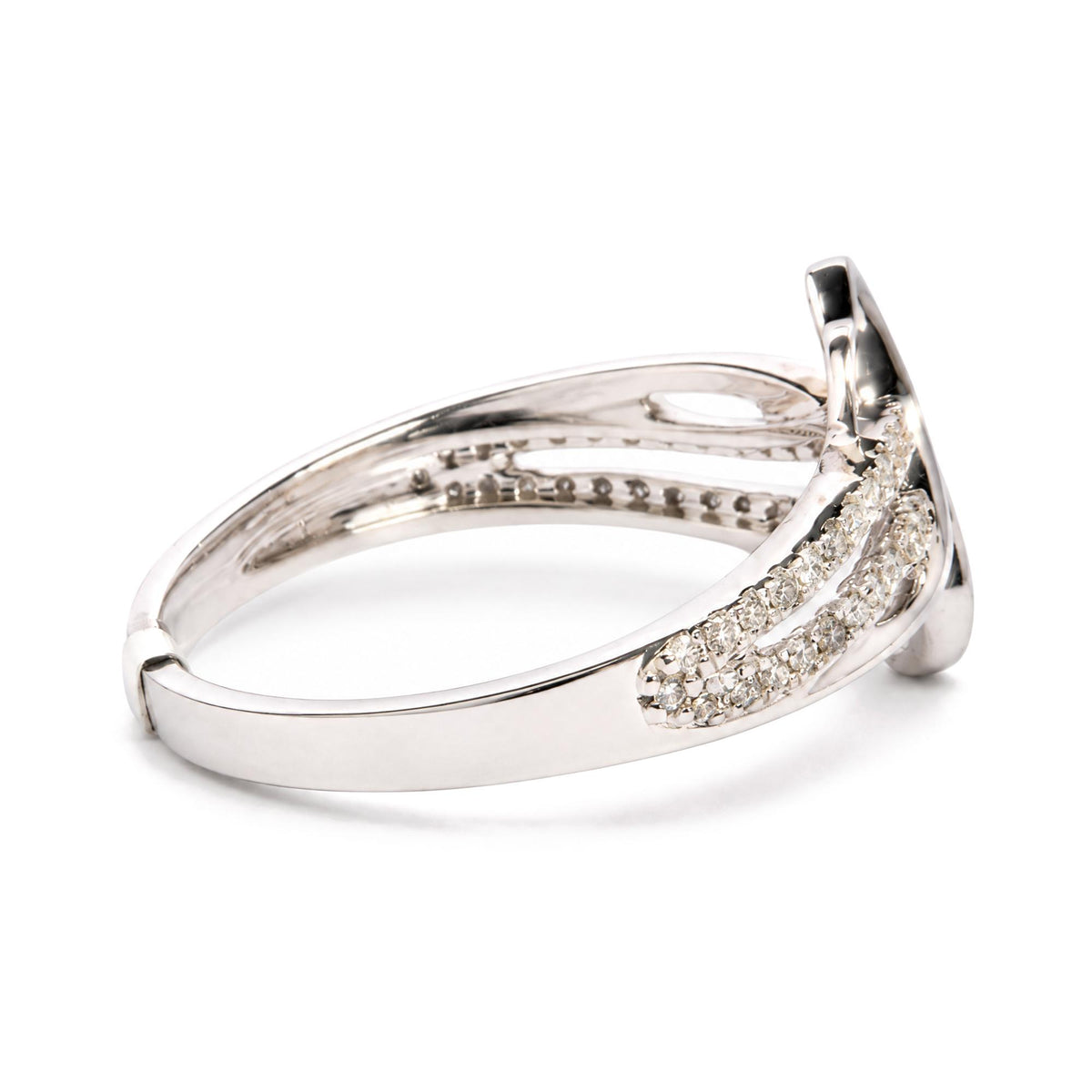 Close-up side angle of a white metal ring with multiple rows of round white gemstones in prong settings.