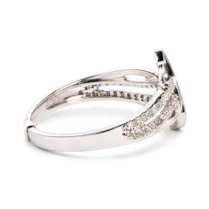 Close-up side angle of a white metal ring with multiple rows of round white gemstones in prong settings.