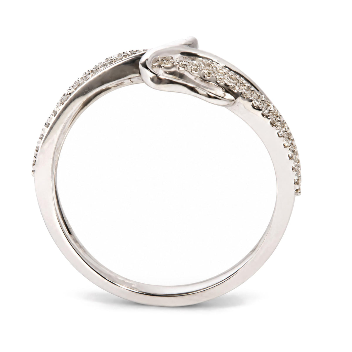 Close-up side angle of a white metal ring with round white gemstones set along the band in prong settings.