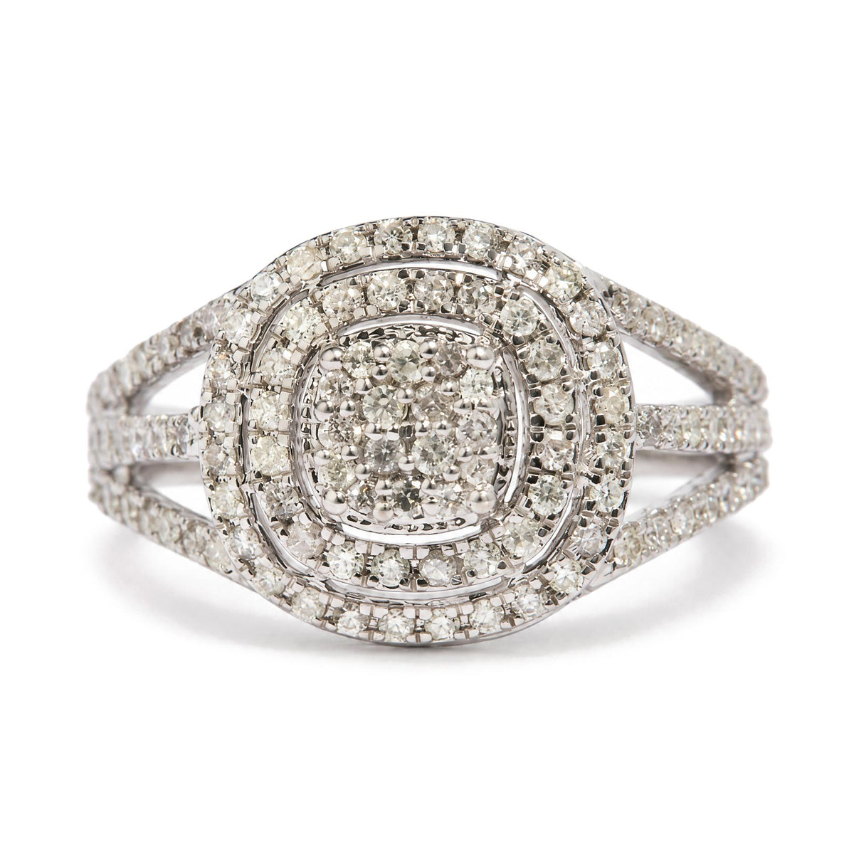 Close-up front angle of a white metal ring featuring multiple rows of round white gemstones in prong settings arranged in a concentric square and circular pattern.