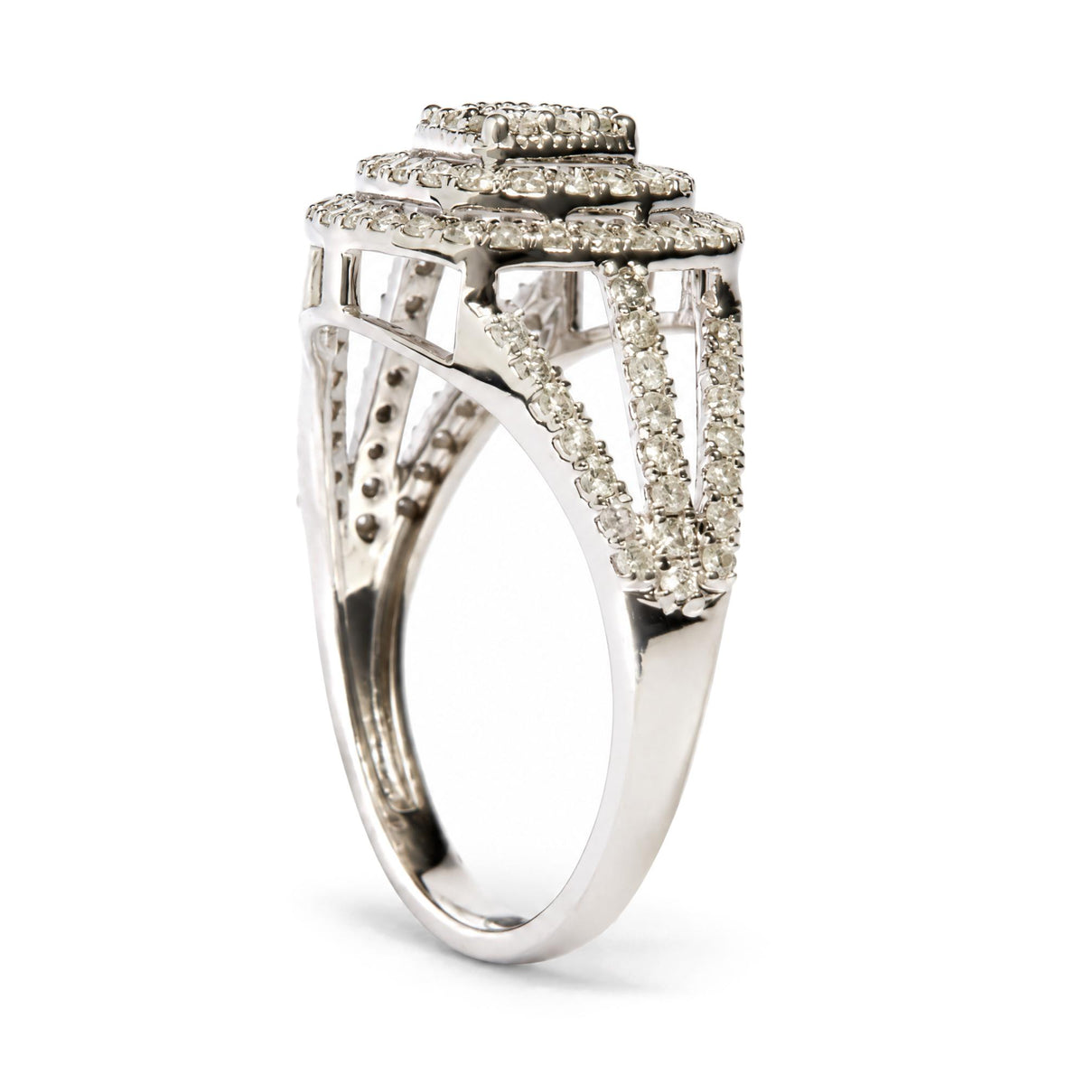 Close-up front angle of a white metal ring with three-tiered rectangular settings, each adorned with round white gemstones in prong settings, and split shank band also encrusted with white gemstones.