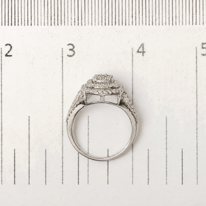 Close-up top view of a white metal ring with multiple rows of small round white gemstones in prong settings, shown on a scale.