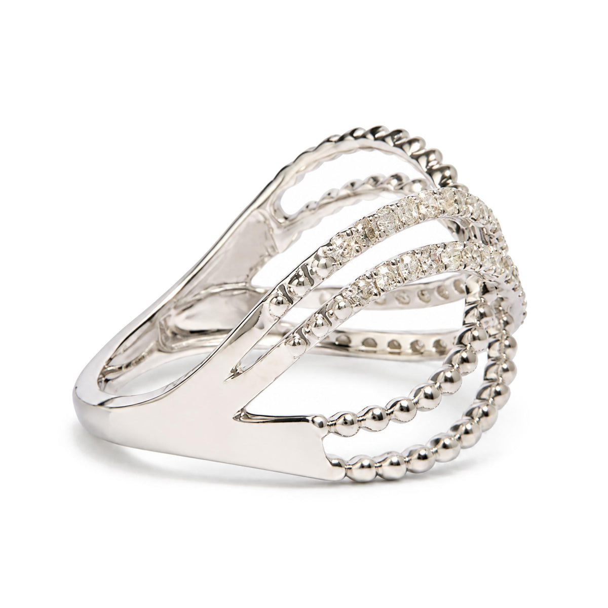 Close-up side angle of a white ring featuring multiple curved bands, some adorned with round white gemstones in prong settings and others with a beaded design.