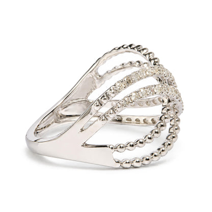 Close-up side angle of a white ring featuring multiple curved bands, some adorned with round white gemstones in prong settings and others with a beaded design.