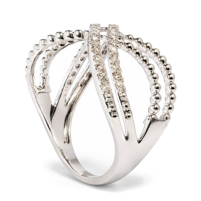 Close-up front angle of a white metal ring featuring multiple intertwined bands, with some bands adorned with round white gemstones in prong settings.
