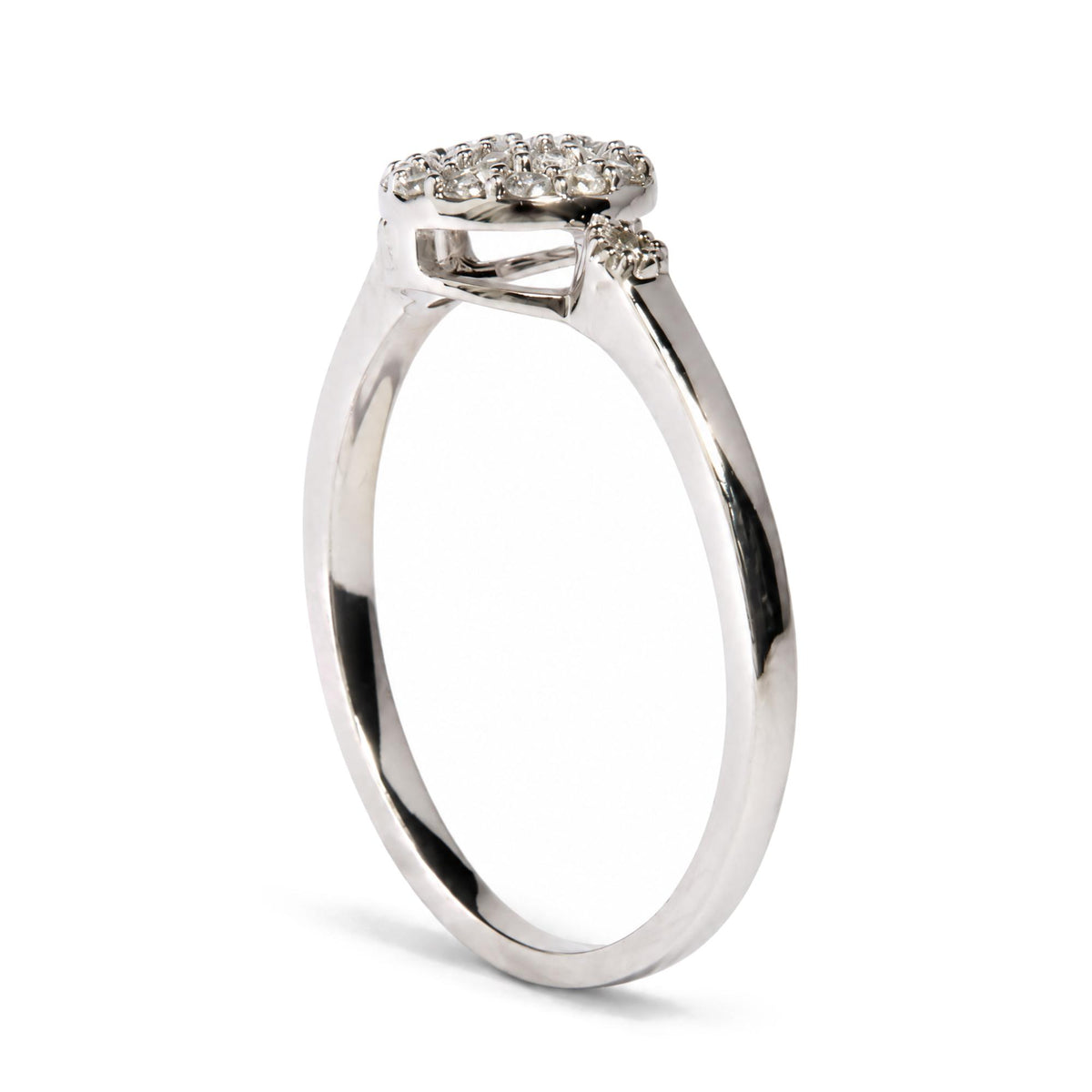Close-up side angle of a white metal ring featuring multiple round white gemstones in prong settings on the top surface.