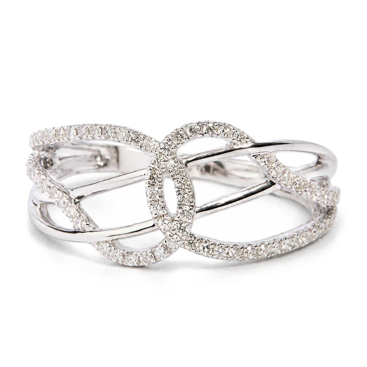 Close-up front angle view of a white metal ring with an intricate open design, featuring multiple round white gemstones set in prongs across the surface.