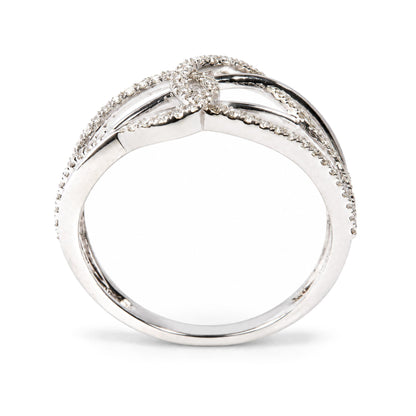 Close-up front angle of a white metal ring featuring multiple rows of round white gemstones in prong settings forming a delicate intertwined design.