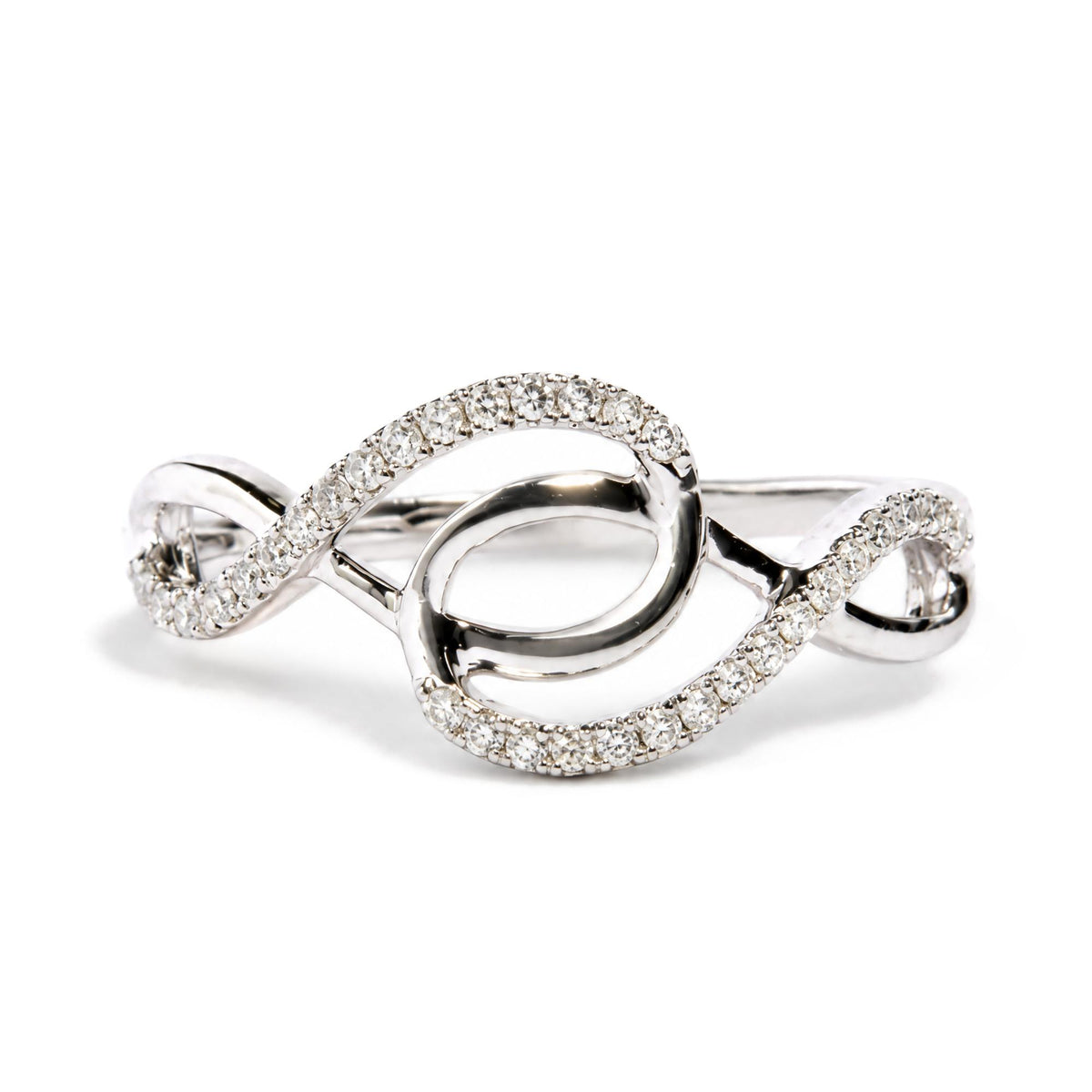 Close-up front angle of a white metal ring featuring intertwined loops adorned with round white gemstones in prong settings.