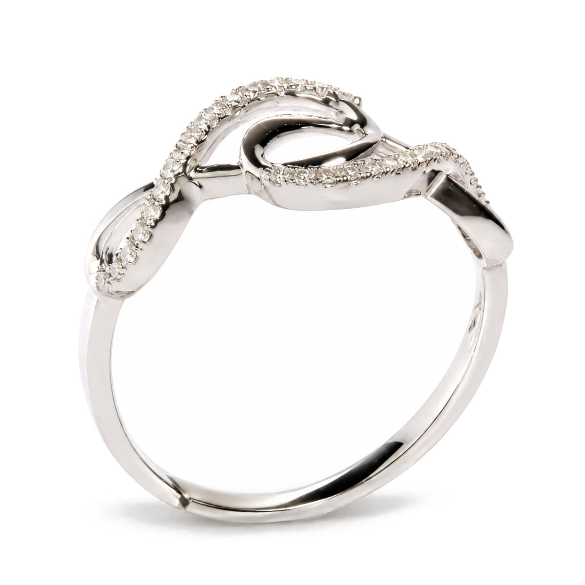 Close-up front angle of a white metal ring with an open, twisted band design featuring two rows of round, prong-set white gemstones.