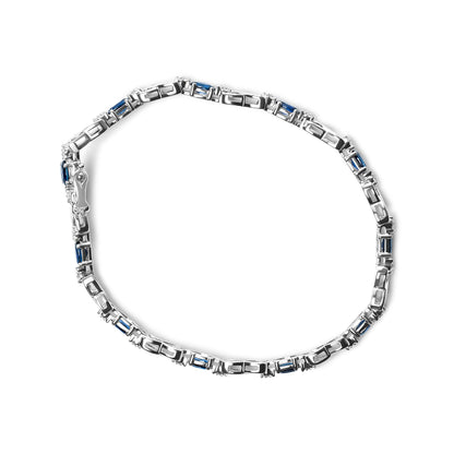 Top-down angle of a white metal bracelet featuring alternating oval blue gemstones and round white gemstones in prong settings.