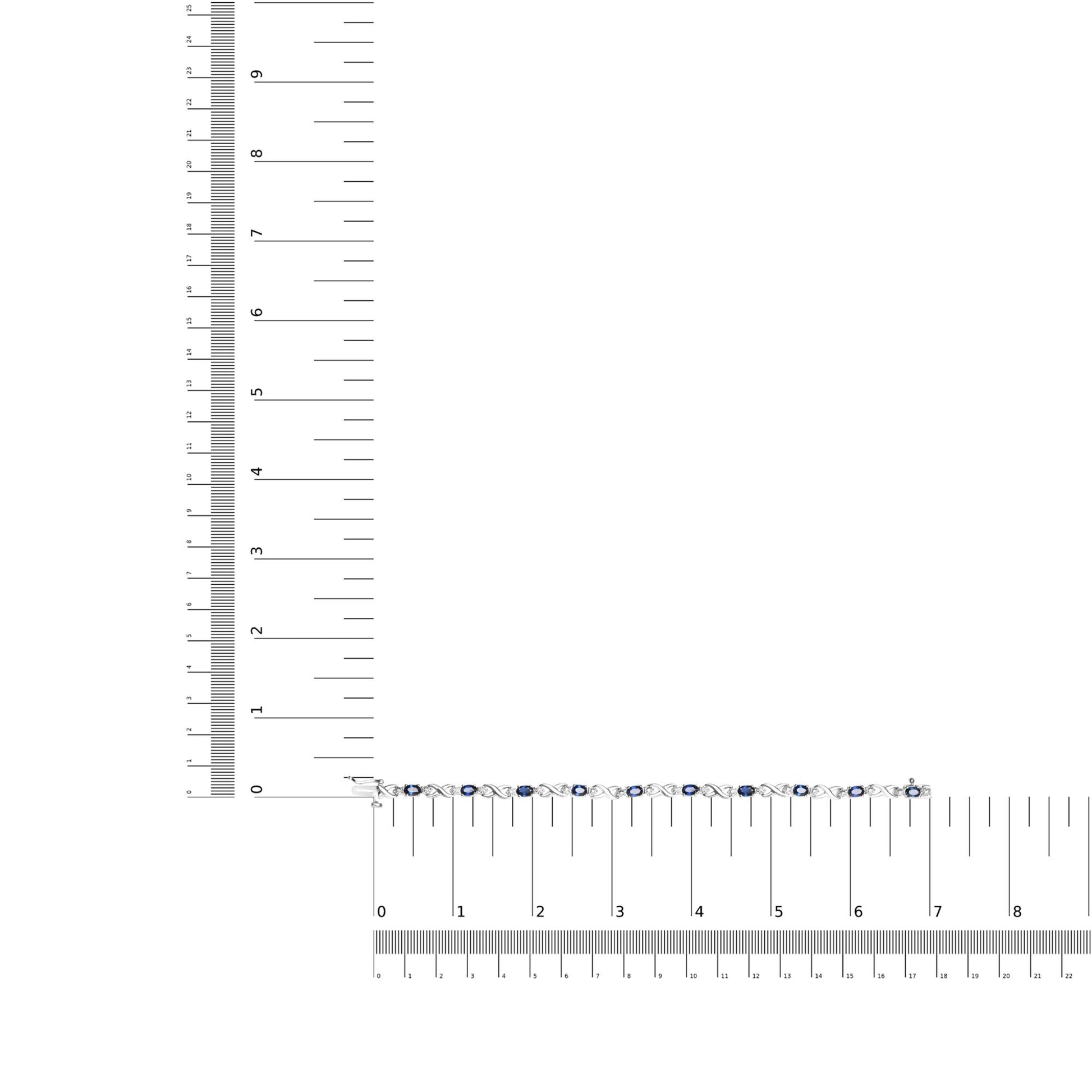 White metal bracelet with alternating white round gemstones and blue oval gemstones in prong settings, displayed flat on a ruler for size reference, top-down angle.