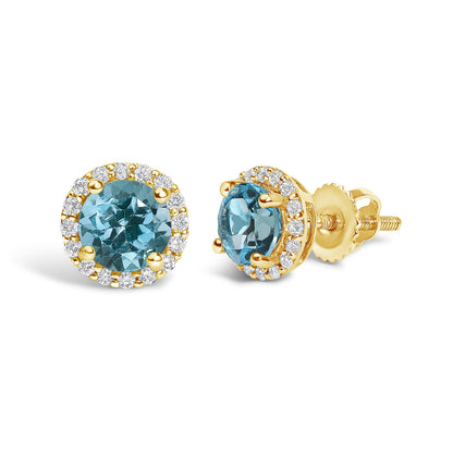 Pair of yellow metal stud earrings shown from front and side angles, each featuring a central round blue gemstone with a four-prong setting, surrounded by a halo of round white gemstones in shared prong settings.