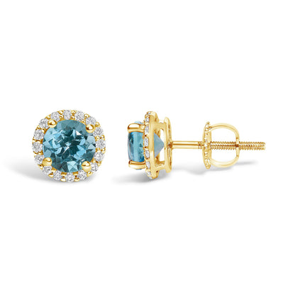 Pair of yellow metal stud earrings with round blue gemstones center and surrounded by small white gemstones, shown in a side and front angled view.