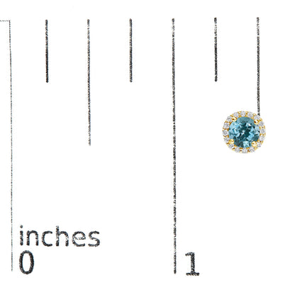 Yellow metal round earrings with a central blue gemstone surrounded by a halo of white gemstones, shown on a scale with inch measurements, front-facing angle.