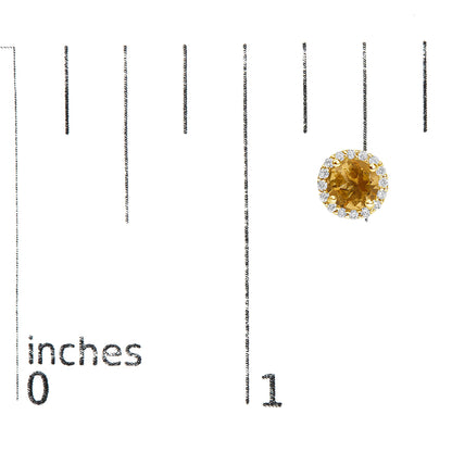 Single yellow metal stud earring with a round orange gemstone center surrounded by a halo of small round white gemstones, shown on a scale at a front angle.
