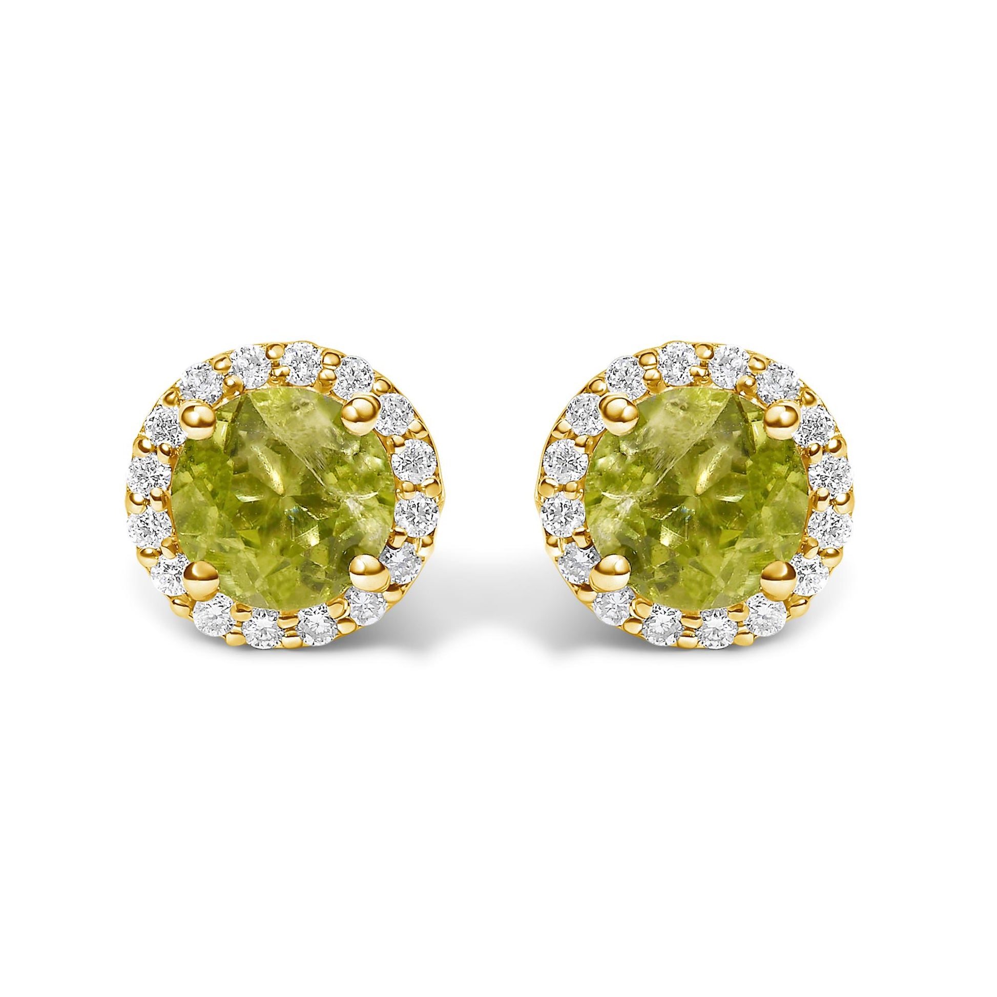 Close-up front view of yellow metal round stud earrings with green round gemstones in four-prong settings, surrounded by a halo of white round gemstones in shared prong settings.