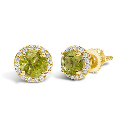 Close-up front and side angled view of a pair of yellow metal stud earrings featuring round green gemstones prong-set in the center, surrounded by a halo of round white gemstones in shared prong settings.