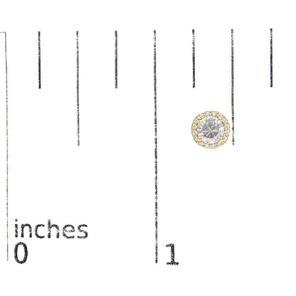 Yellow metal round stud earring with a central white gemstone surrounded by white round gemstones in a shared prong setting, shown on a scale.