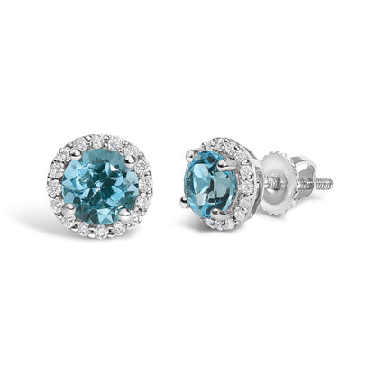 Pair of round stud earrings shown from front and side angles, featuring a central blue gemstone surrounded by a halo of small white gemstones in shared prong settings on white metal.