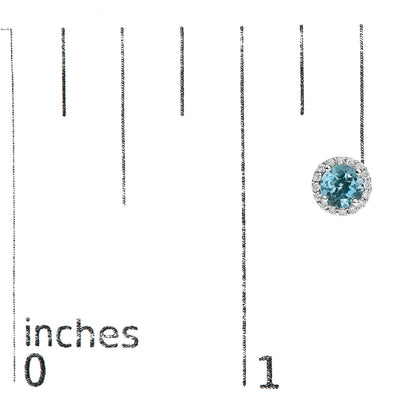 Close-up front view of a single round blue gemstone earring surrounded by smaller white gemstones, shown on a scale.