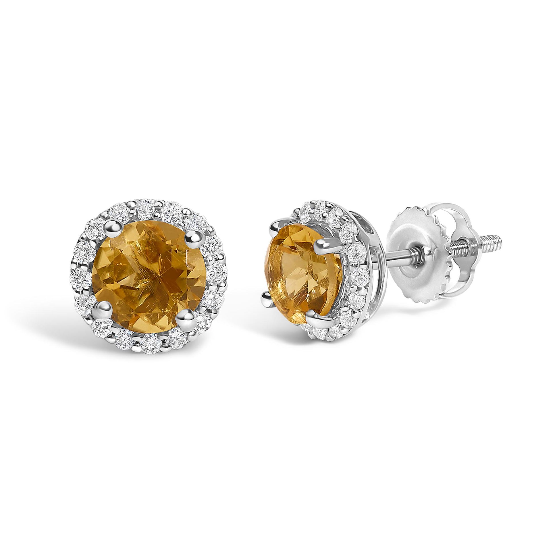 Pair of white metal stud earrings with round orange gemstones in the center, surrounded by a halo of small white gemstones, shown in a front and side angle on a white background.