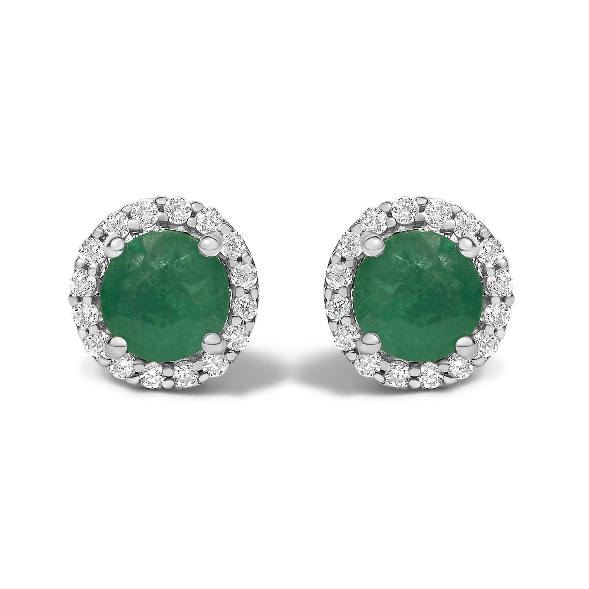 Front view of a pair of white metal stud earrings featuring round green gemstones in four-prong settings, each surrounded by a halo of small round white gemstones in shared prong settings.