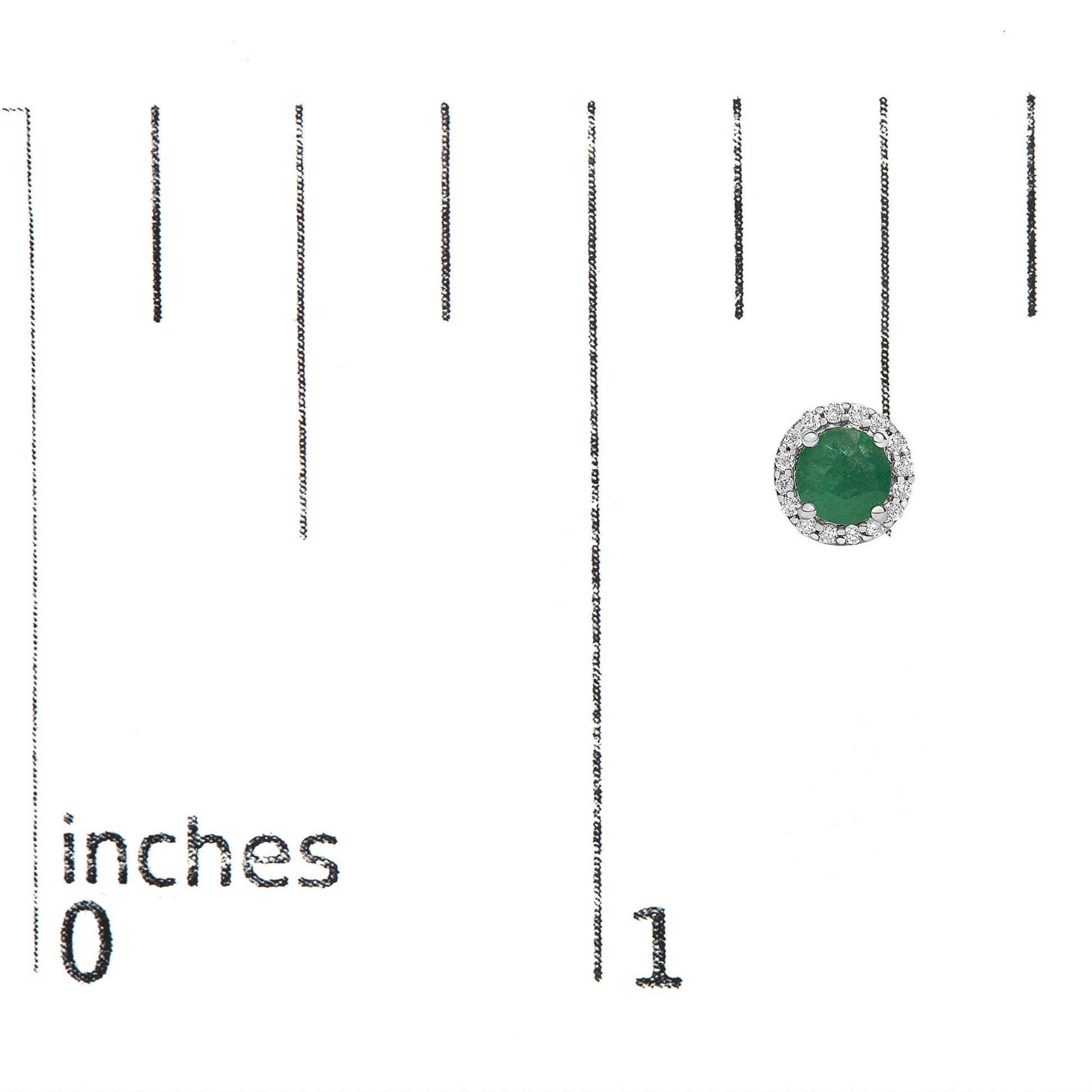 Single white metal earring with a round green gemstone center surrounded by a circle of small white gemstones, shown on a scale with inch markings, top-down angle.