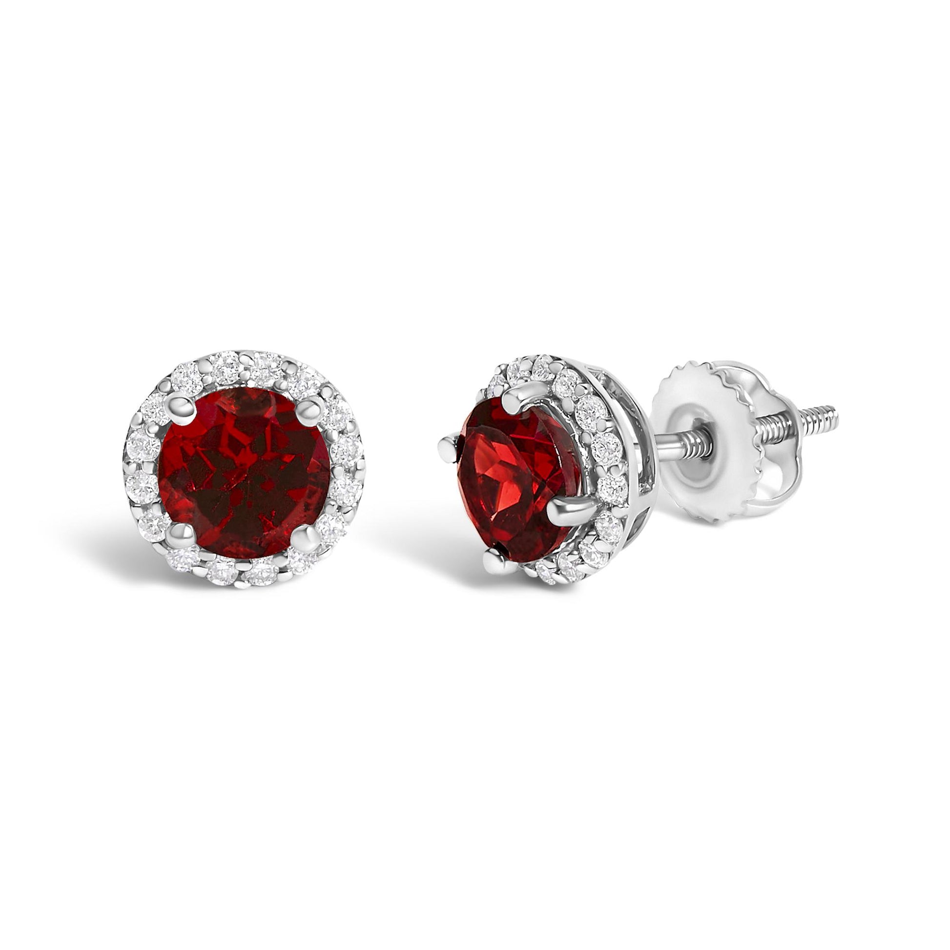 Pair of white metal stud earrings with round red gemstones surrounded by a halo of small white gemstones, shown in a close-up angled side and front view on a white background.