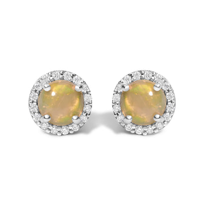 Front view of white metal round stud earrings featuring a central multi-color round opal gemstone in a four-prong setting, surrounded by a halo of small white round gemstones in shared prong settings.