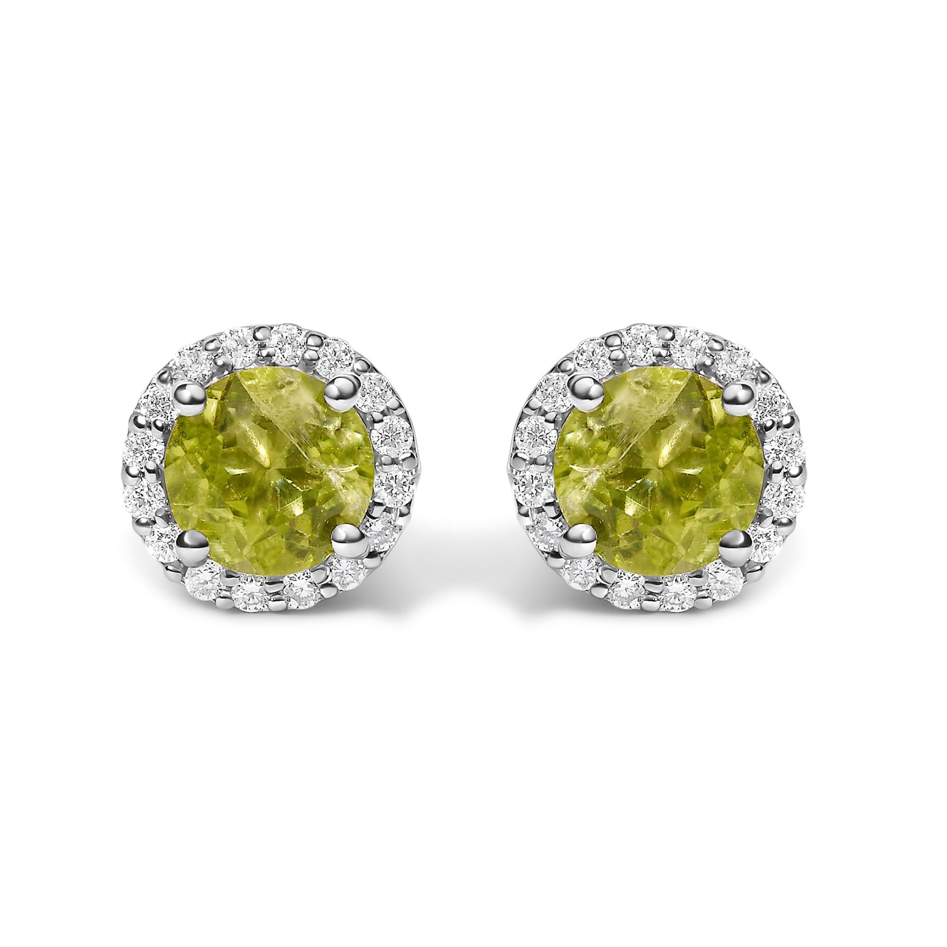 Close-up front view of white metal round stud earrings featuring a central green round gemstone surrounded by small white round gemstones in shared prong settings.