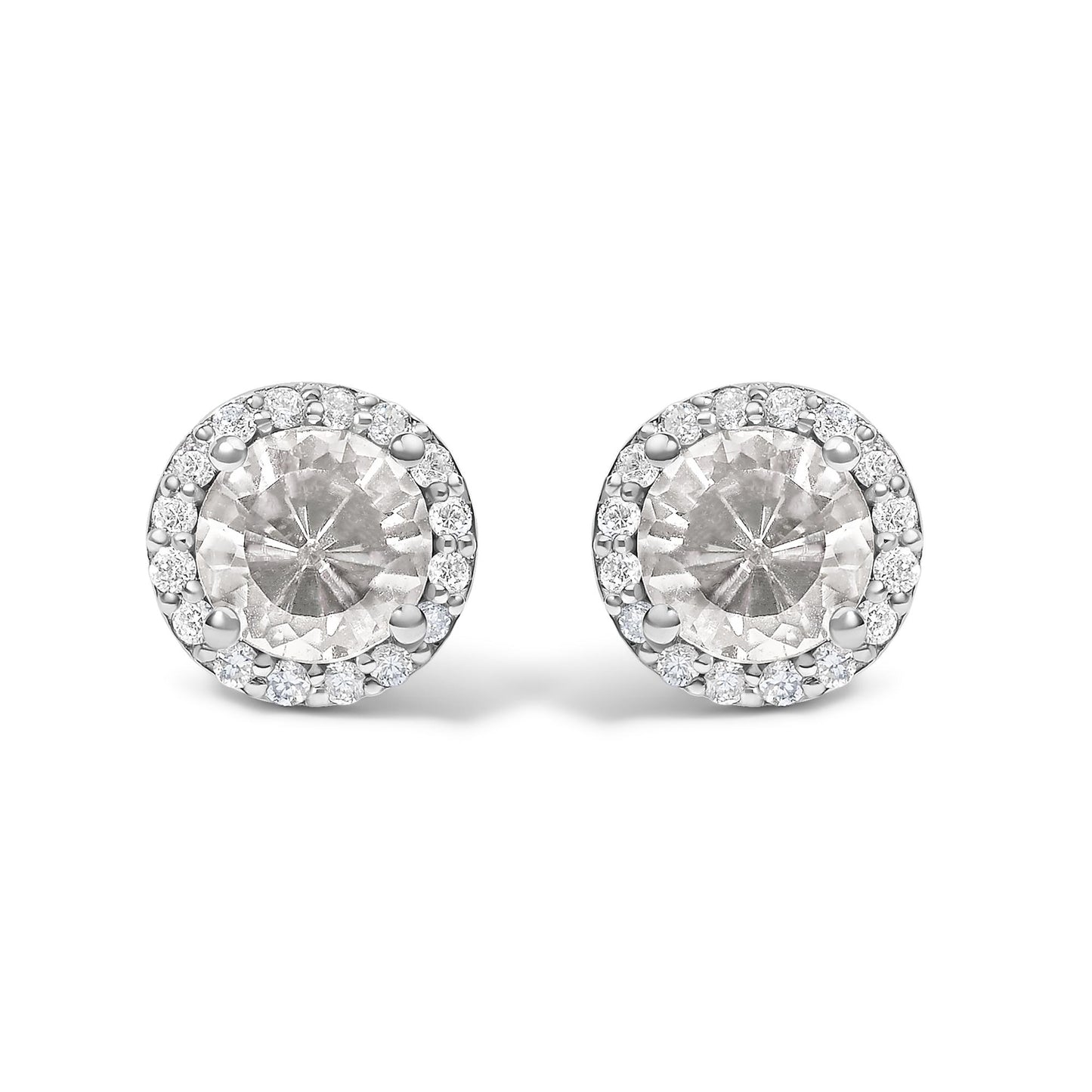 Close-up front view of a pair of round white metal stud earrings featuring a large central round white gemstone with four prongs, surrounded by a halo of smaller round white gemstones in shared prong settings.