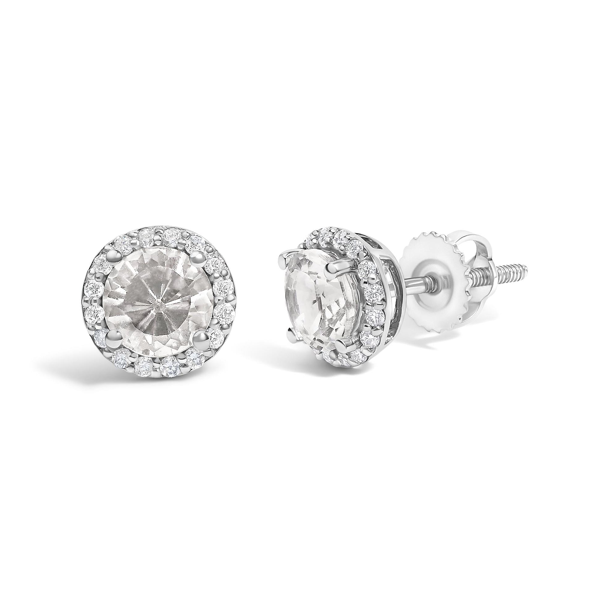 Pair of white metal stud earrings with round white gemstones in 4-prong settings surrounded by a halo of smaller round white gemstones in shared prong settings, shown from front and side angles on a white background.