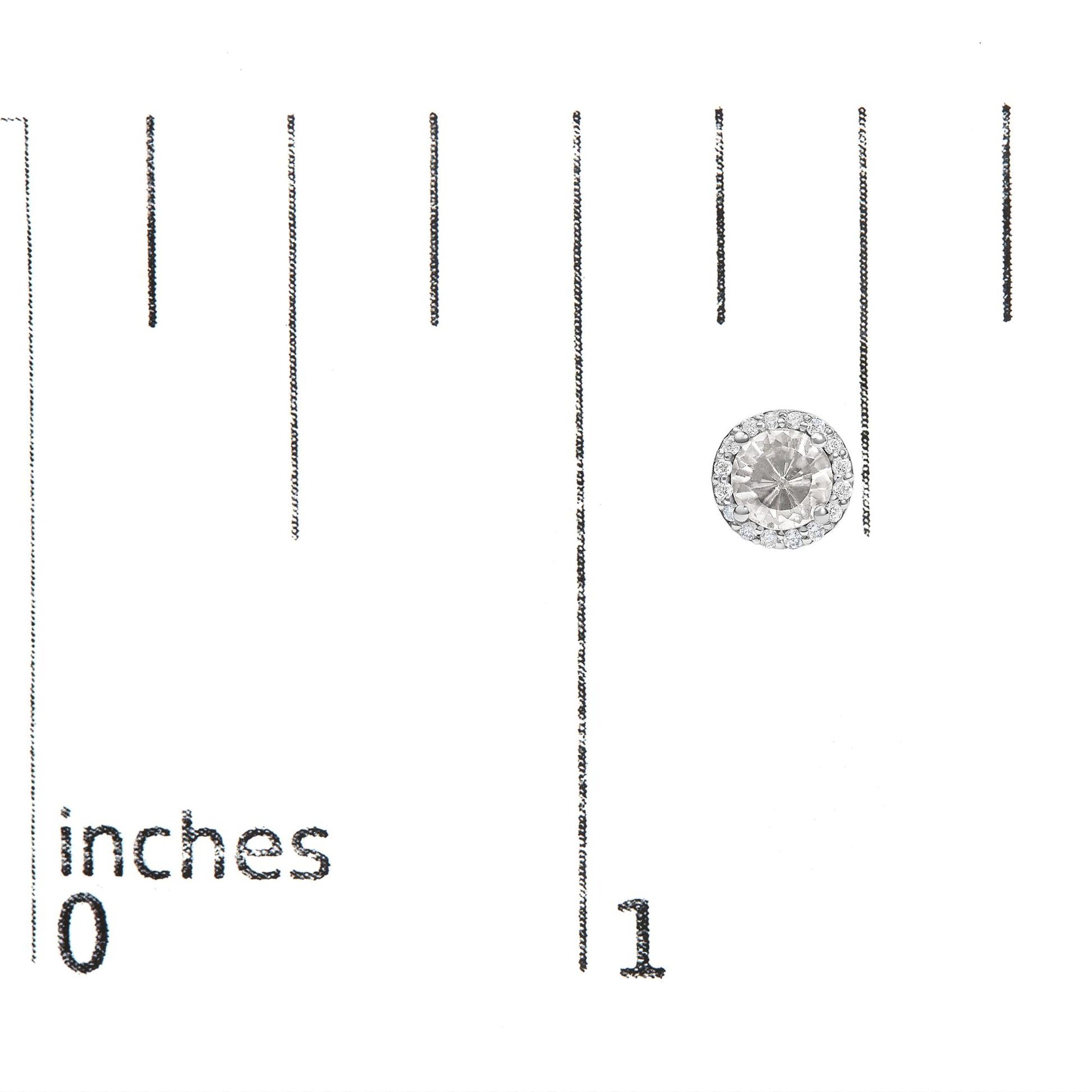 Single round white gemstone earring with smaller white gemstones surrounding it, shown on a scale photographed from above.