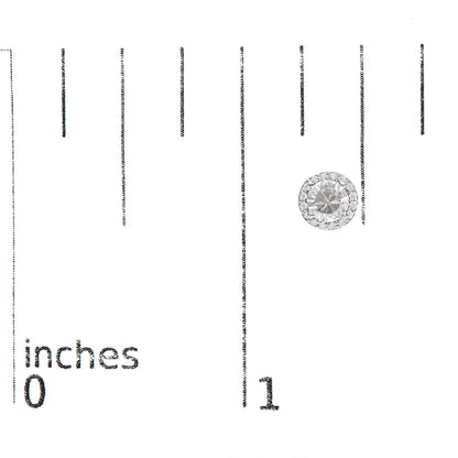 Single round white gemstone earring with smaller white gemstones surrounding it, shown on a scale photographed from above.