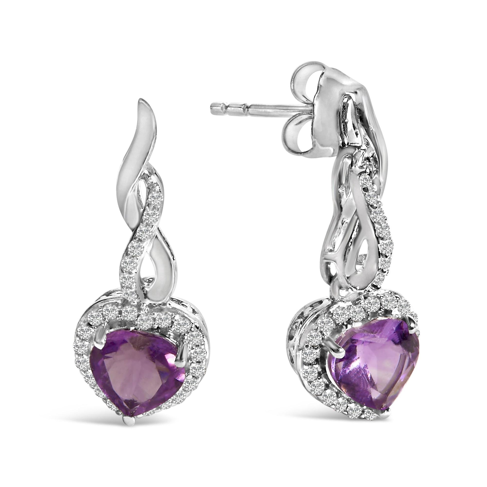 Pair of white metal earrings with heart-shaped purple gemstones surrounded by small white round gemstones, shown in close-up from a front and side angle.