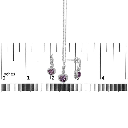 Set of white metal jewelry including a heart-shaped purple gemstone pendant necklace and matching earrings with round white gemstones, shown on a ruler scale from front and side angles.