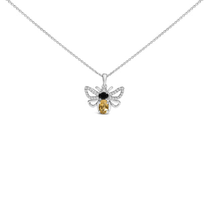 Front view of a white metal necklace with a bee-shaped pendant featuring one oval orange gemstone, one oval black gemstone, and multiple small round white gemstones, shown on a white background.