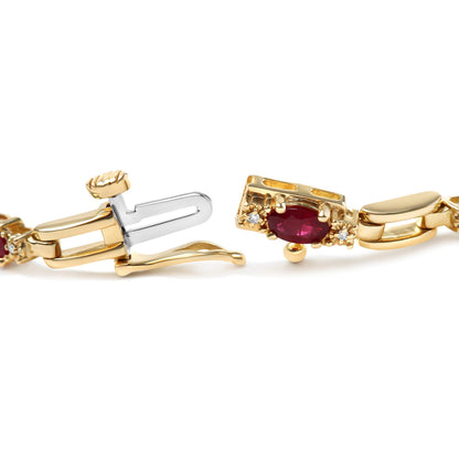 Close-up side angle of a yellow bracelet clasp featuring an oval red gemstone flanked by small round white gemstones in prong settings.