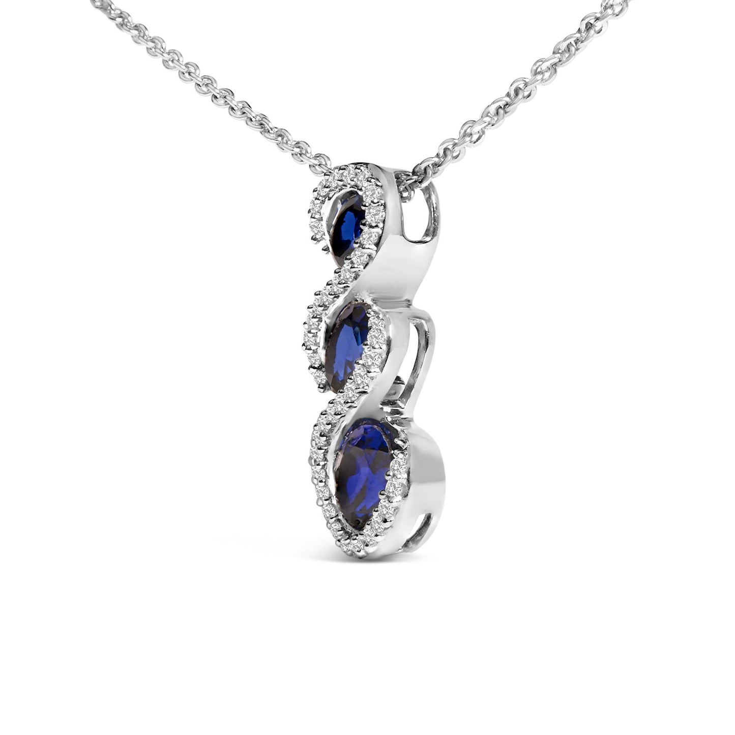 White metal necklace with a pendant featuring three oval blue gemstones vertically aligned, surrounded by numerous small round white gemstones, shown in a close-up angled view.