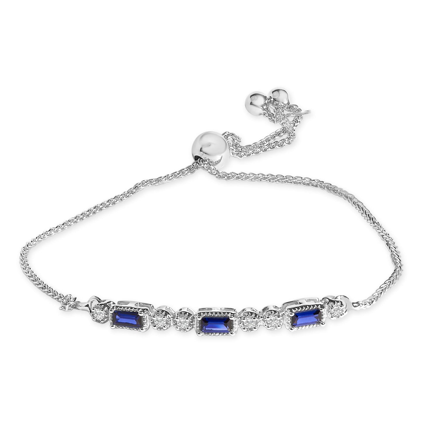 White metal bracelet with alternating blue baguette-shaped gemstones and white round gemstones, shown in a top-down view.