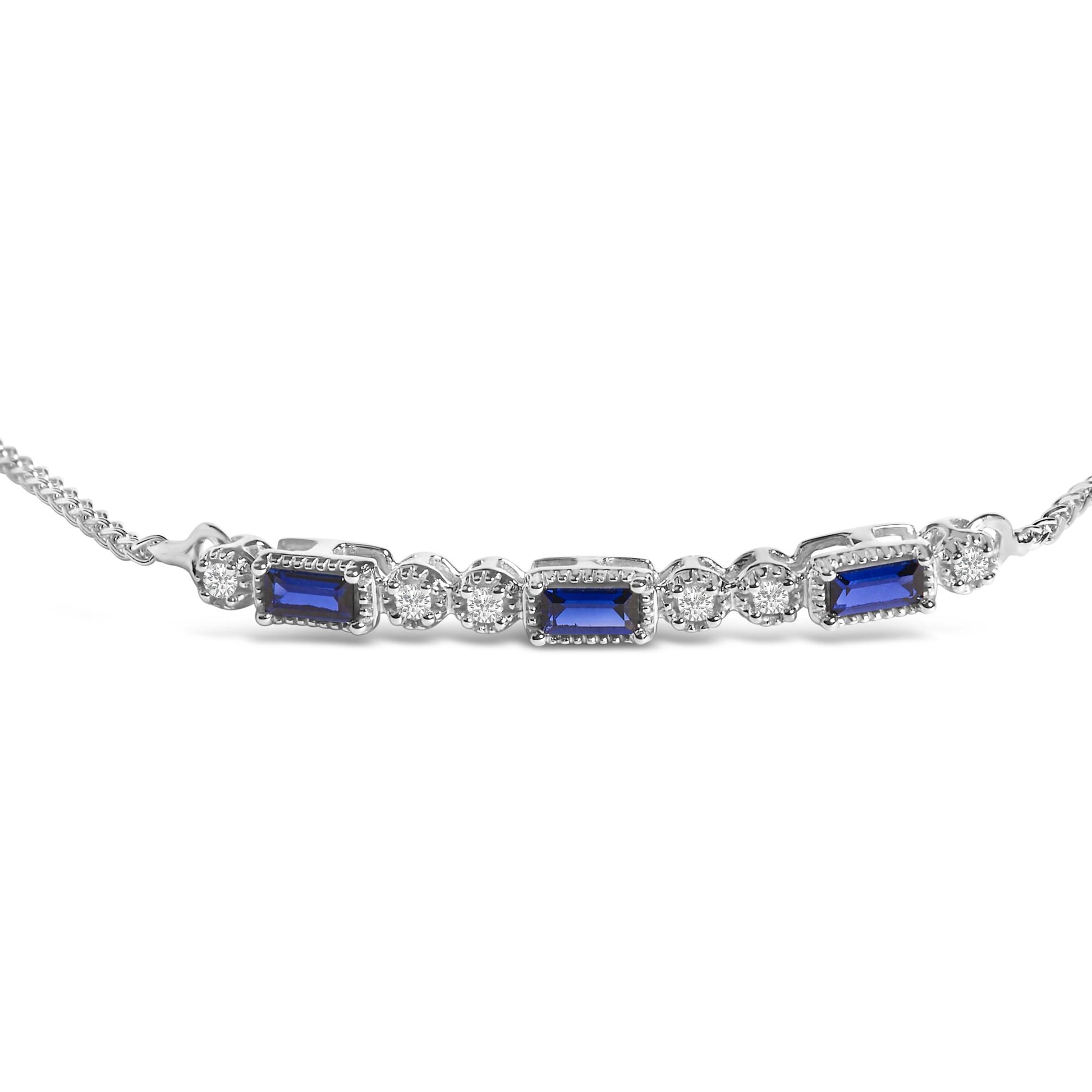 Close-up front angle of a white metal bracelet with alternating rectangular blue gemstones and round white gemstones in prong settings.