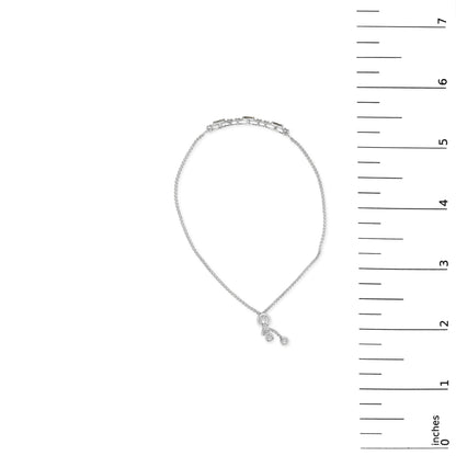 Bracelet in white metal shown on a scale, featuring blue baguette-shaped gemstones and white round-shaped gemstones in a chain design, viewed from above.