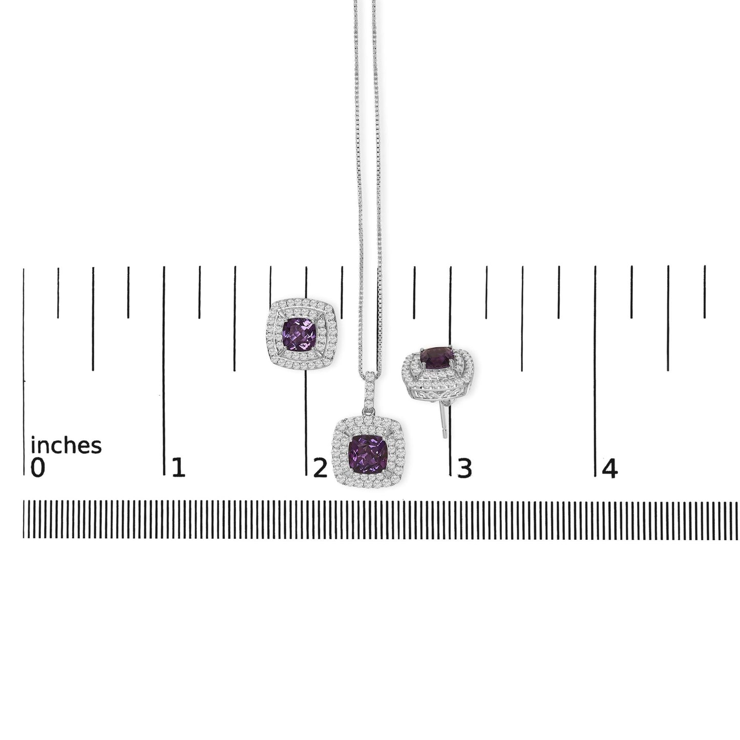 Jewelry set shown on a scale, featuring a pendant necklace and two stud earrings with cushion-shaped purple gemstones surrounded by multiple rows of small round white gemstones in prong settings, photographed from the front.