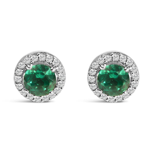 Pair of white metal stud earrings with round green gemstones surrounded by smaller round white gemstones, shown in a front-facing angle on a white background.
