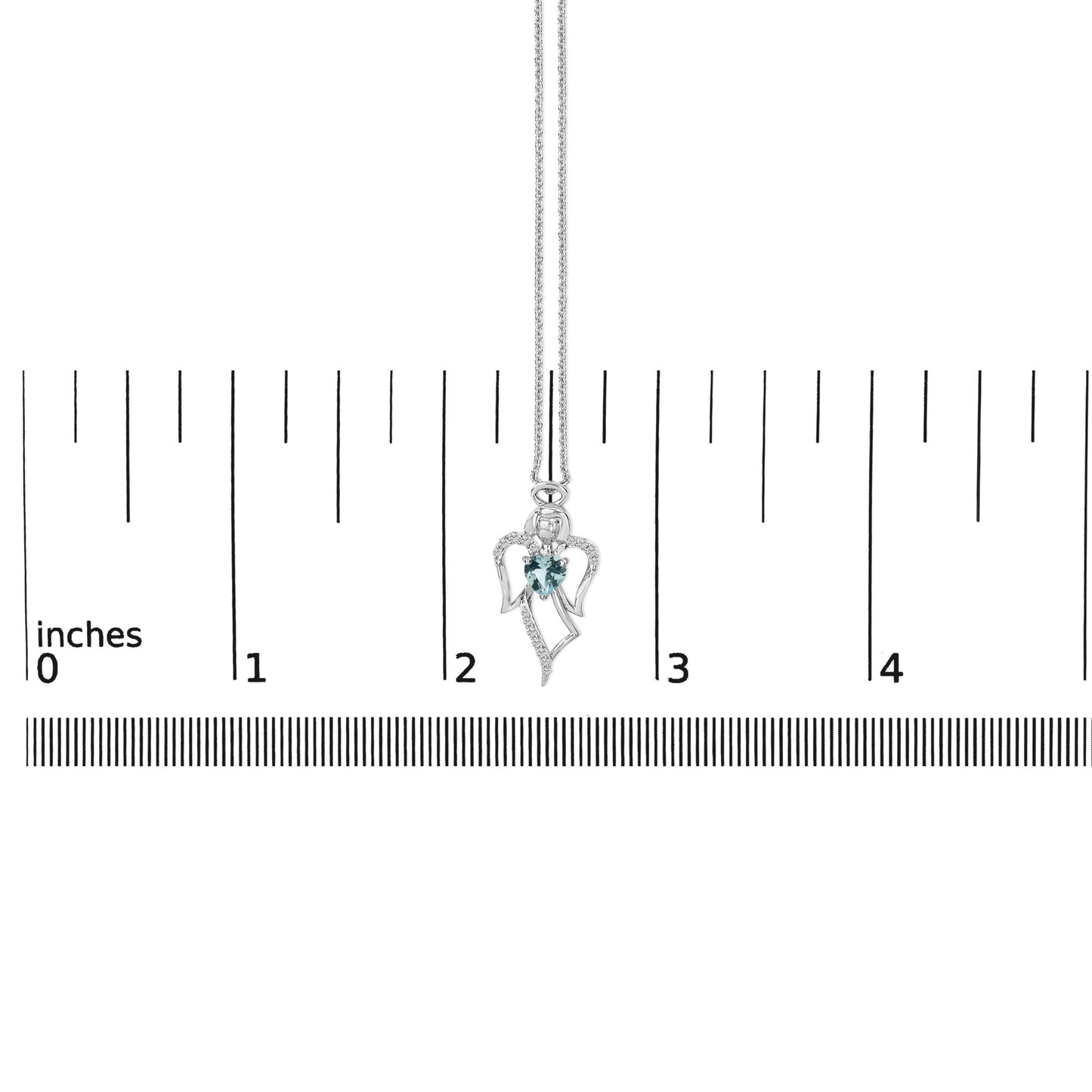 White metal angel-shaped necklace with a blue heart-shaped gemstone in the center and multiple small white round gemstones along the wings, shown on a scale.