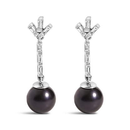 Front view of a pair of white metal drop earrings featuring white baguette-shaped gemstones set in a channel setting along the vertical bar and cluster at the top, with a large dark round gemstone dangling at the bottom.