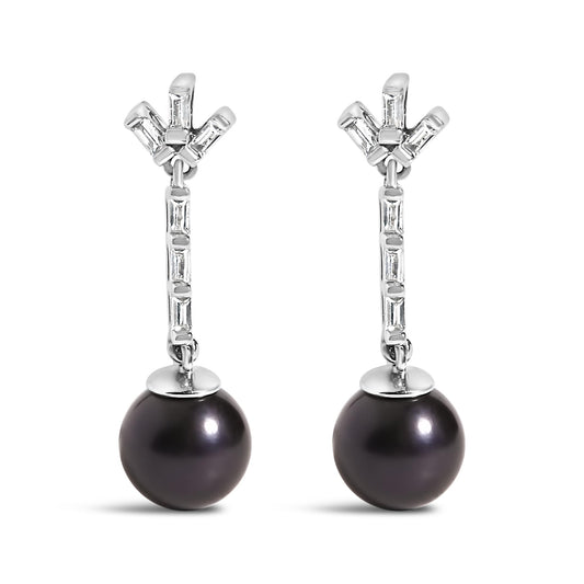 Front view of a pair of white metal drop earrings featuring white baguette-shaped gemstones set in a channel setting along the vertical bar and cluster at the top, with a large dark round gemstone dangling at the bottom.