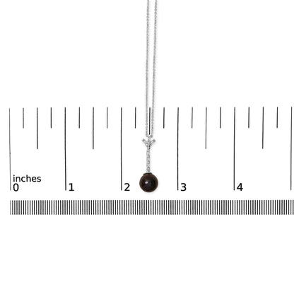 White metal necklace shown on a scale, featuring a pendant with a vertical row of six white baguette-shaped gemstones in channel settings, topped with a Y-shaped arrangement of gemstones, and a round dark gemstone hanging at the bottom, displayed from a front angle.