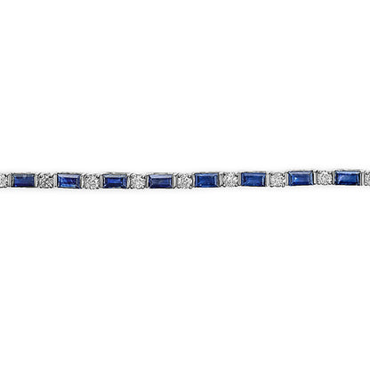 Straight-on view of a white bracelet with alternating round white gemstones in prong settings and blue baguette-shaped gemstones in channel settings.